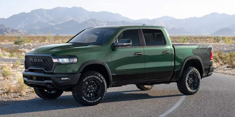 A 2026 RAM 1500 parked on a lone road with its powerful tires in Springfield, MI