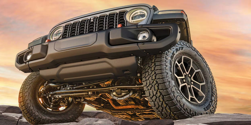 2026 Jeep Gladiator cresting a cliff off-road in Springfield, MI with flexible lease options